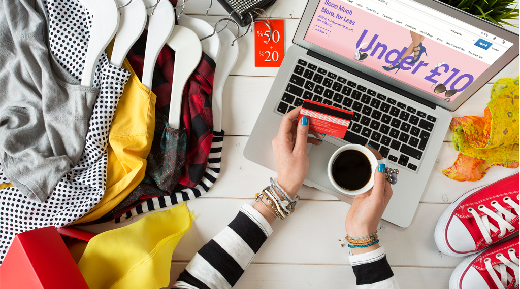 "Person using laptop on furniture with computer keyboard, shoe, handbag, sneaker, credit card"